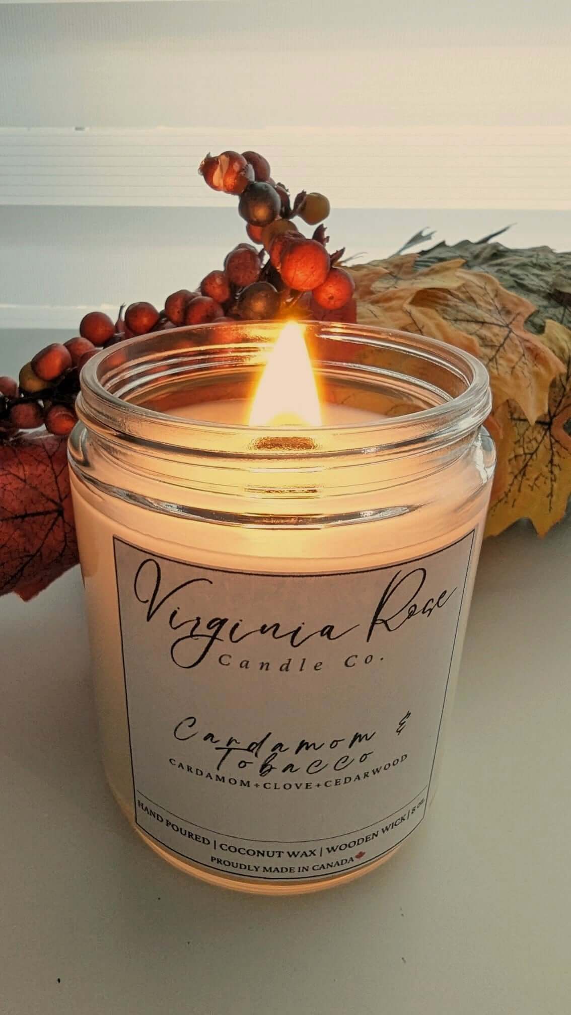A lit Cardamom & Tobacco Candle from Virginia Rose Candle Co. 